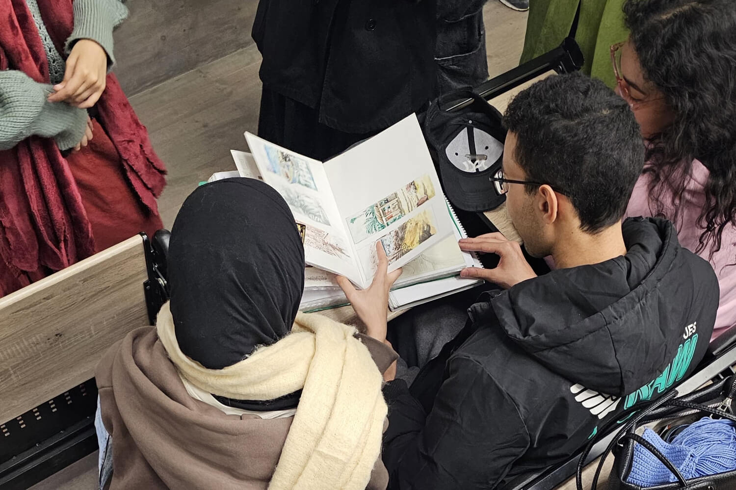 BUE students reviewing Melbrins' sketchbooks